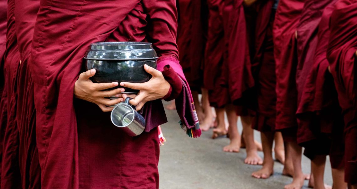 detail-of-buddhist-monks-crowd-and-person-holding-PKCY67V.jpg